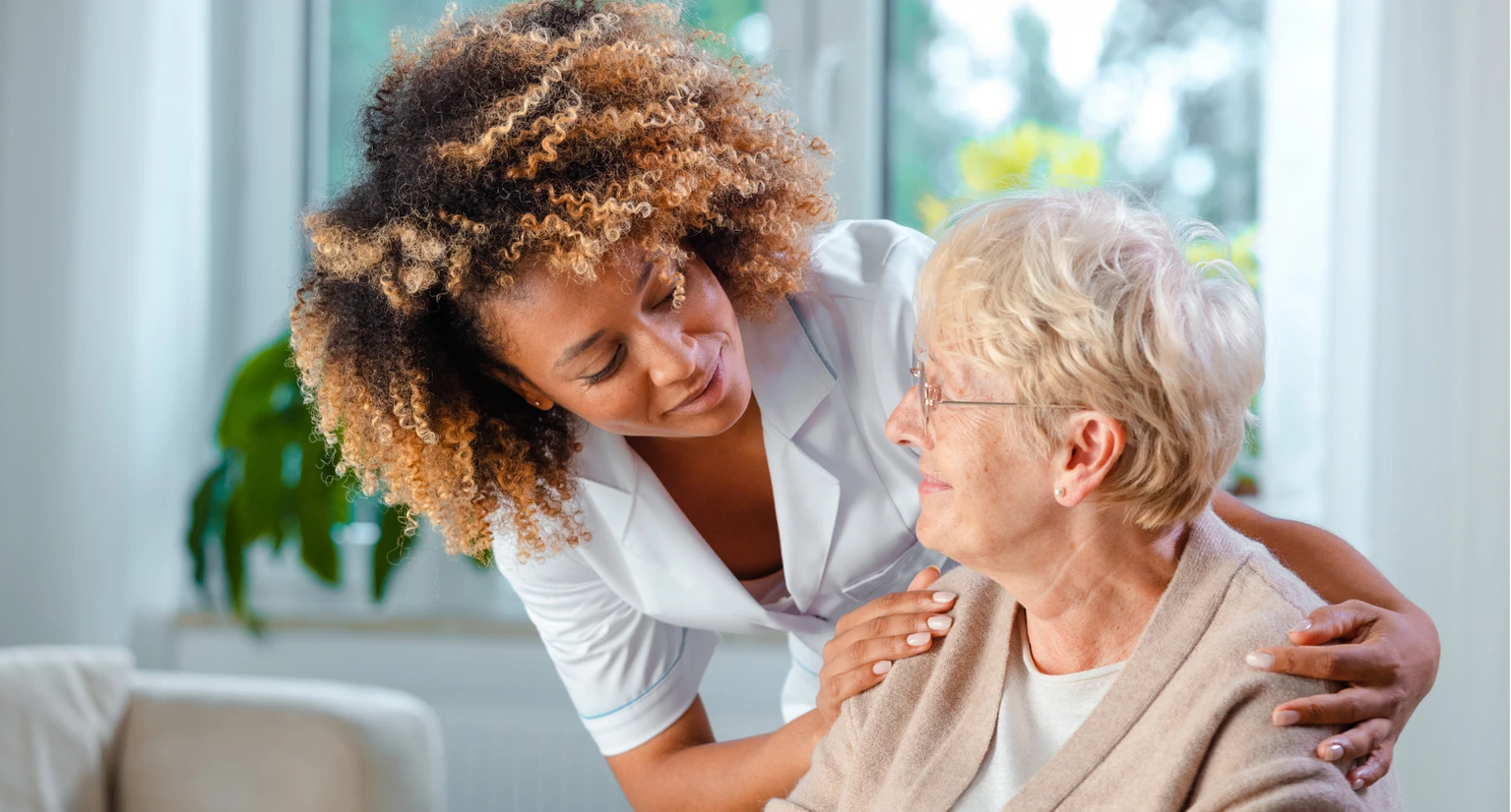 Senior care services caregiver tending to senior elder